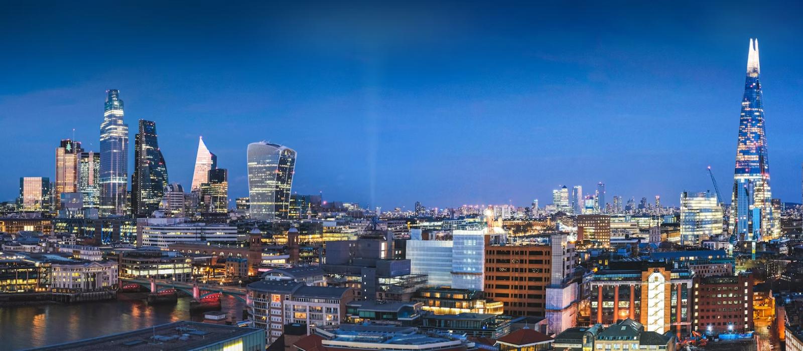 Aerial photography of city with high-rise buildings during night time